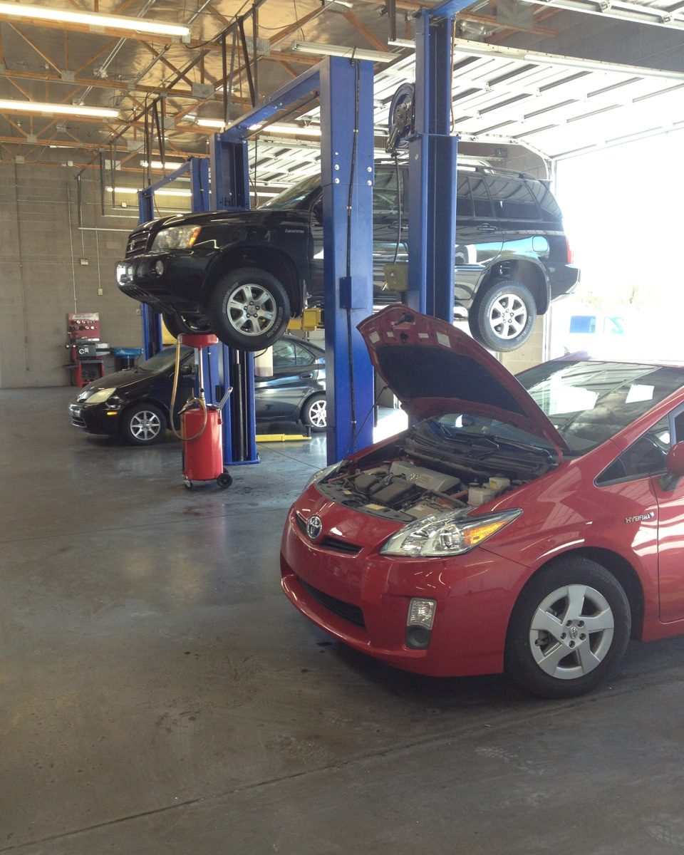 Red Prius with the hood open in a Yota Pros bay